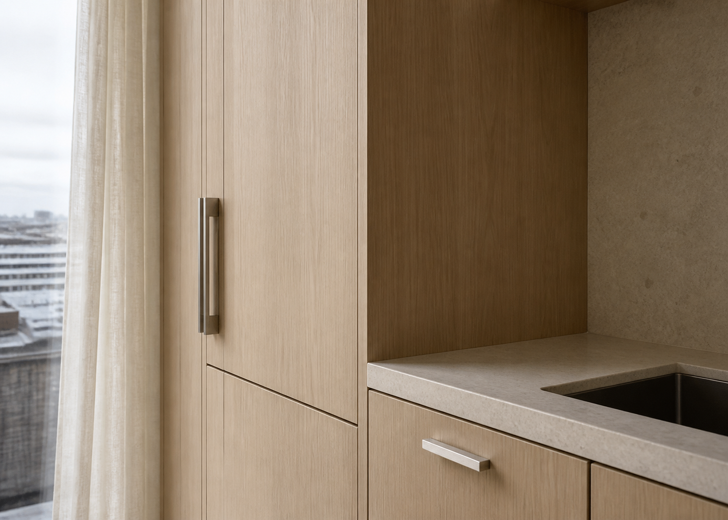 Honed stone and brushed metal add variation without introducing visual noise.